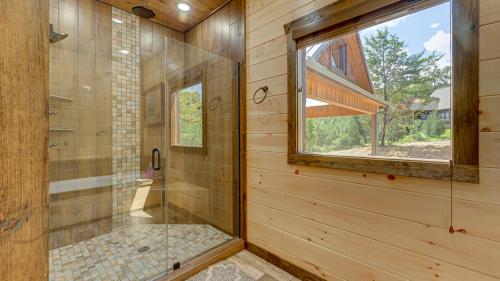 a bathroom with a shower with a glass door at 4 Leaf Clover in Blue Ridge
