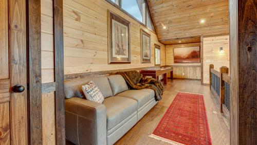 a living room with a couch in a wooden cabin at 4 Leaf Clover in Blue Ridge