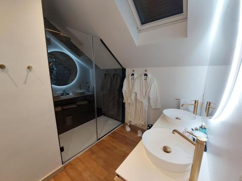 a white bathroom with a toilet and a shower at Cha Cha de Loup Luxe B&B - Vakantiewoning in Rendeux