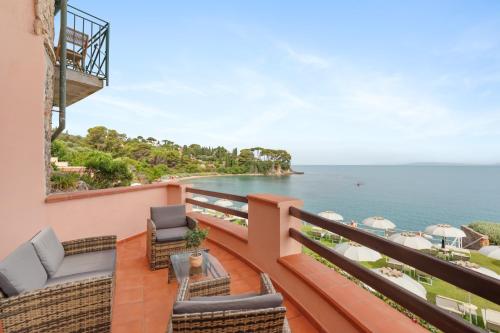 a balcony with chairs and a view of the ocean at Hotel Villa Domizia in Porto Santo Stefano