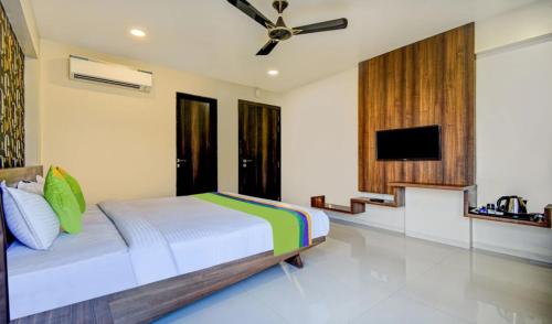 a bedroom with a bed and a flat screen tv at Olive Home Stay in Agra