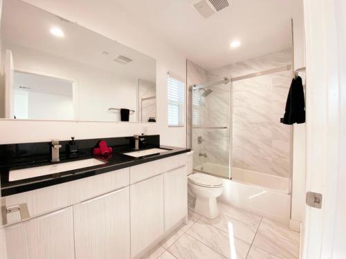 a bathroom with a sink and a toilet and a shower at Modern 3BR Home in Mid-City in Los Angeles