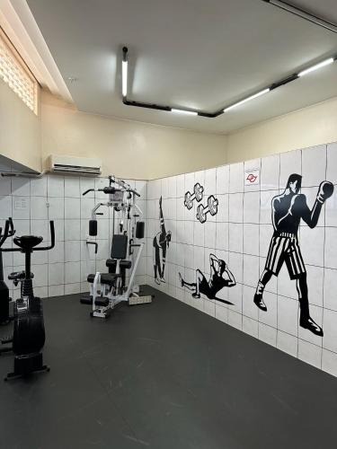 a room with a gym with a mural of a man at Hotel Saint Paul in Sao Jose do Rio Preto