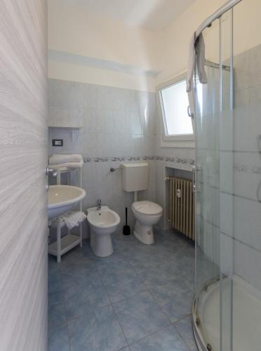 a bathroom with two toilets and a sink and a shower at FARE BnB - Room & Breakfast Santa Maria in Reggio Emilia