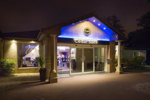a store with a blue sign on the front of it at Dalziel Park Hotel in Motherwell