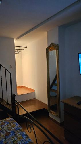 a bedroom with a mirror and a bed and a dresser at Casa Ruffo in Francavilla di Sicilia