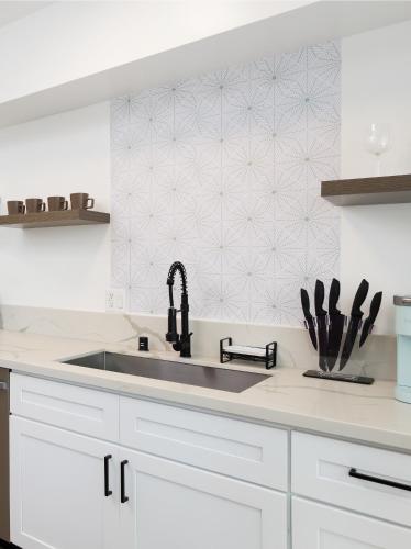 a kitchen with a sink and a counter top at Fenix Hotel Hollywood in Los Angeles