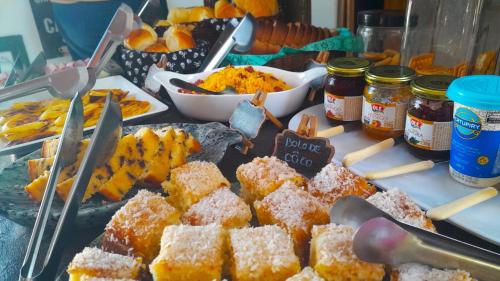 a table topped with lots of different types of food at Pousada do Rock in Arraial d'Ajuda