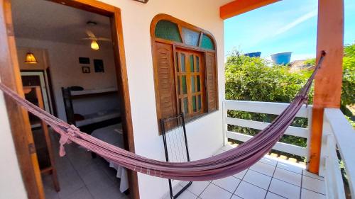 a hammock on the balcony of a house at Pousada do Rock in Arraial d'Ajuda