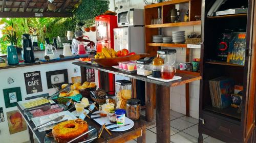 a kitchen with a table with food on it at Pousada do Rock in Arraial d'Ajuda