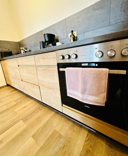 a kitchen with a stove with a towel on the oven at Apartment Altstadtliebe in Bautzen