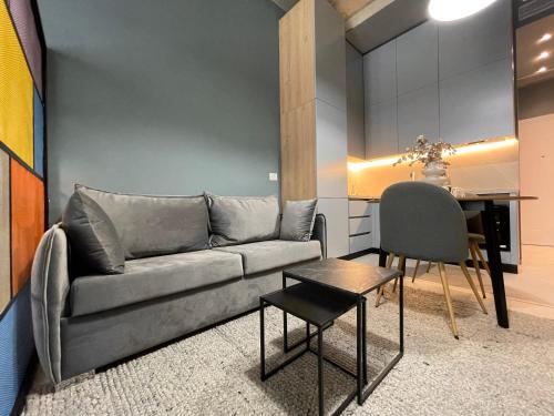a living room with a couch and a table at Ambassador Skyline Apartments in Tirana