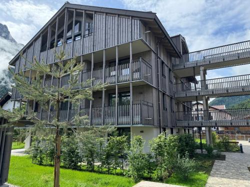 an apartment building with balconies and a tree at Alpenkind in Mittenwald