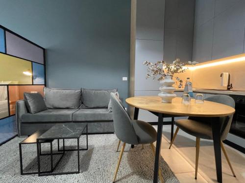 a living room with a couch and a table at Ambassador Skyline Apartments in Tirana