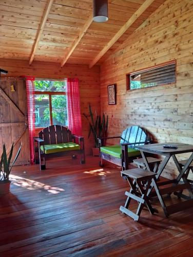 a log cabin with a table and chairs in it at Cabañas Barú Dota in Santa María