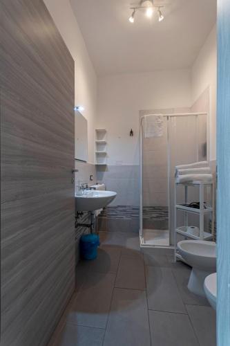 a bathroom with a toilet and a sink and a shower at FARE BnB - Room del Parco in Reggio Emilia