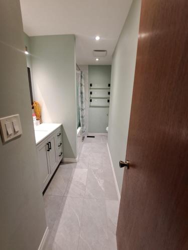 a hallway of a kitchen with a door open at Your home away from home in Oshawa