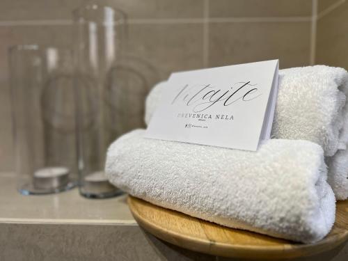 a stack of towels with a sign on top of them at Drevenica Nela - Chalet in Tatras in Zuberec