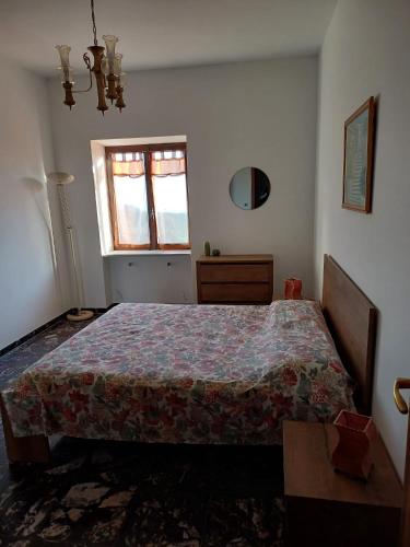 a bedroom with a bed and a window at Casa nel verde !!! in Falconara Albanese