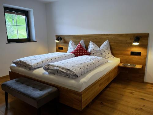 a bedroom with two beds with pillows at Ferienwohnungen Kirchenwirt in Thiersee