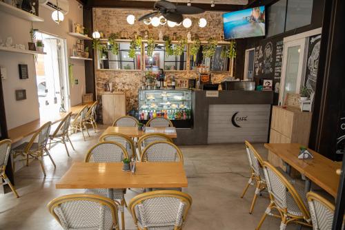 a restaurant with wooden tables and chairs and a bar at Lunalá Hotel Boutique in Cartagena de Indias