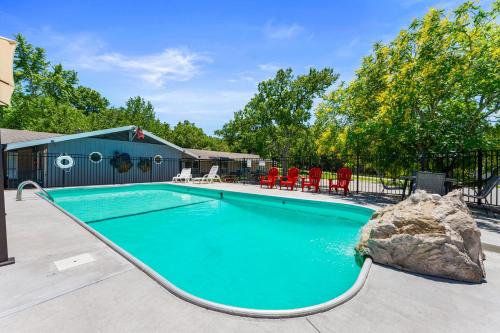a swimming pool with a rock in the middle at Osage Resort in Branson