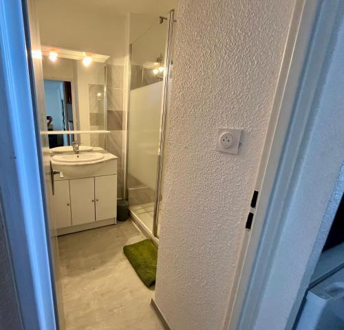 une salle de bain avec douche et lavabo dans l'établissement IPANEMA piscine, plage 4 couchages, au Cap d'Agde