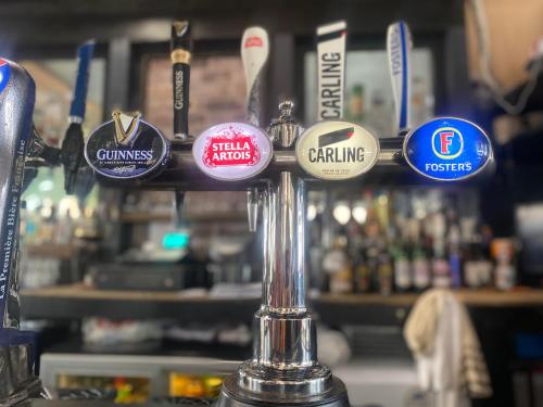 a bunch of pins on a bar pole at The Phoenix Hostel in London