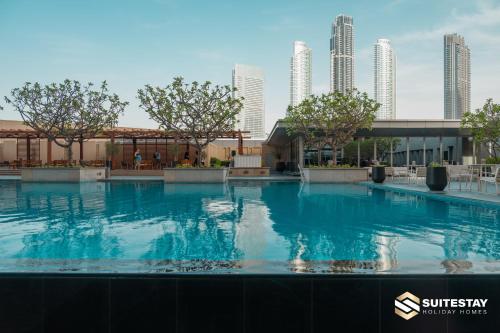 a swimming pool with a city skyline in the background at Emaar Residence Fashion Avenue in Dubai
