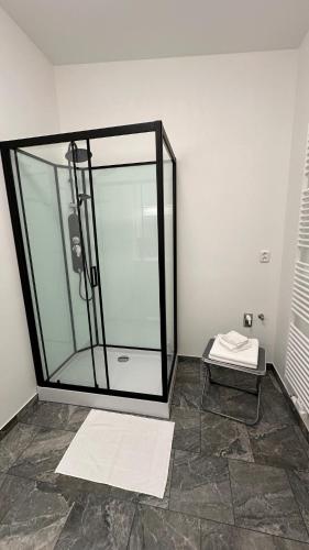 a glass shower in a room with a tile floor at Penzion Slovácko 2 in Ostrožská Nová Ves