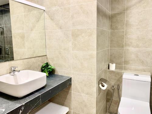 a bathroom with a sink and a toilet at Deco Home @ Aru Suites in Kota Kinabalu
