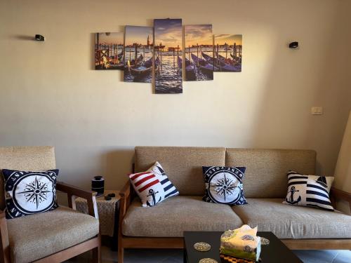 a living room with two chairs and a couch at Golden Sands in El Alamein