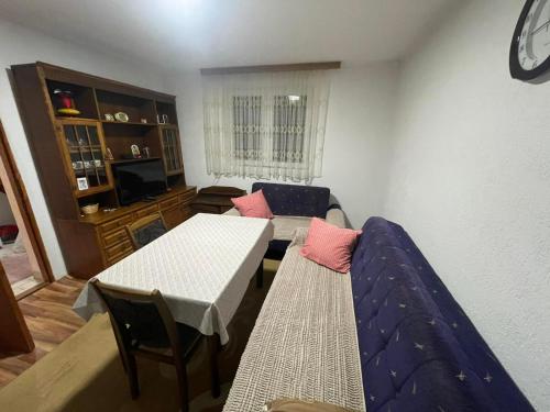 a living room with a bed and a table at Vikendica Vukovic in Foča