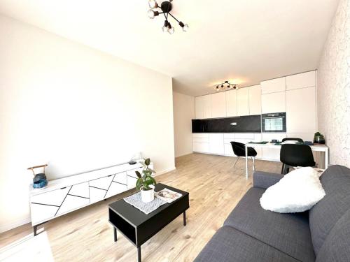 a living room with a couch and a table at City appartment AC & Parking in Prievoz