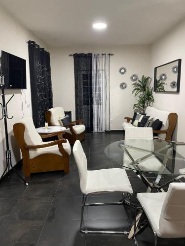 a living room with a glass table and chairs at Alojamento Local Afonso in Macedo de Cavaleiros