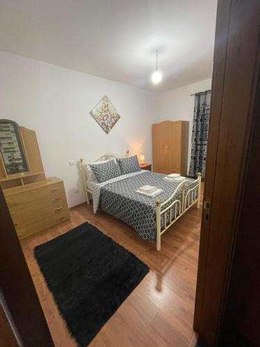 a bedroom with a bed and a dresser in it at Alojamento Local Afonso in Macedo de Cavaleiros