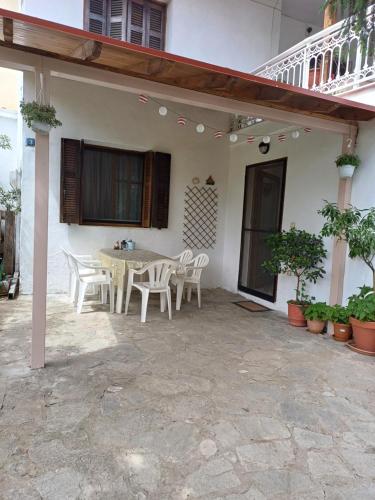 a patio of a house with a table and chairs at Apartment near Olympus mountain in Litochoro