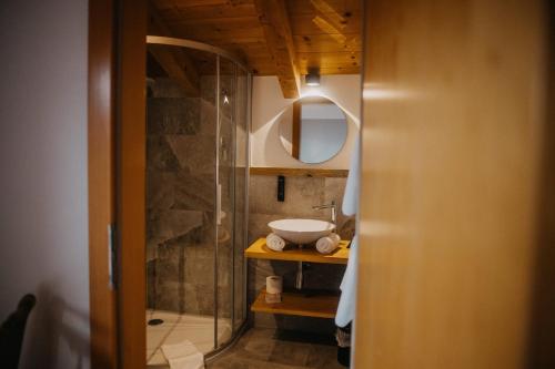 a bathroom with a sink and a shower at Hotel Alpin Tyrol - Kitzbüheler Alpen in Sankt Johann in Tirol