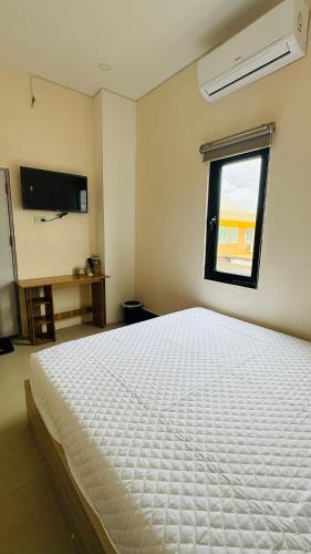 Ένα ή περισσότερα κρεβάτια σε δωμάτιο στο VIENTIANE BB Hostel