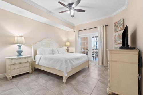 a bedroom with a bed and a ceiling fan at The Oasis at Orange Beach 609 (Phoenix West II) in Orange Beach