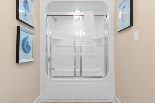 a white refrigerator in a room with two pictures at The Oasis at Orange Beach 609 (Phoenix West II) in Orange Beach