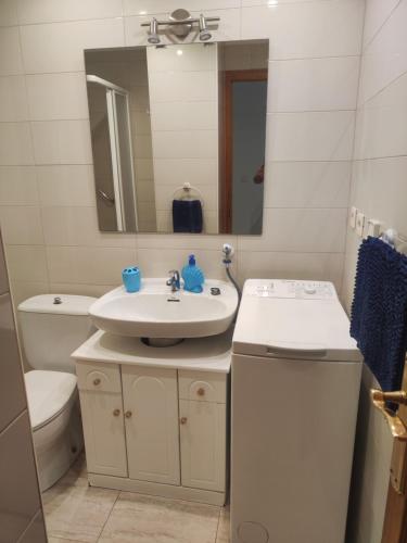 a bathroom with a sink and a toilet and a mirror at Casa Marius in La Mata