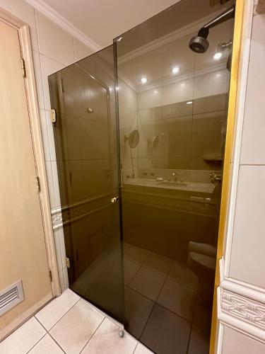 a glass shower in a bathroom with a sink at Hotel Saint Paul in Sao Jose do Rio Preto