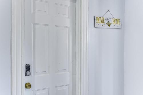 a white door with a hotel room sign on it at Pet-Friendly Stoughton Apartment with Outdoor Space in Stoughton