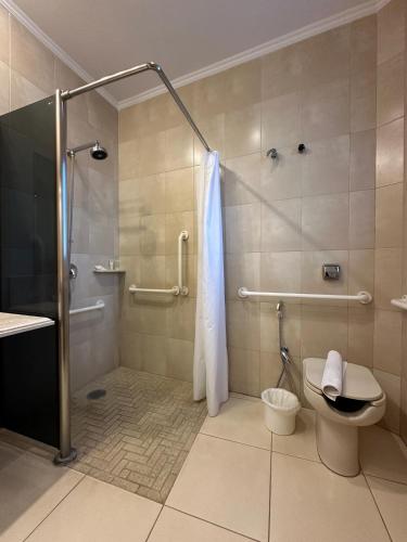 a bathroom with a shower and a toilet at Hotel Saint Paul in Sao Jose do Rio Preto