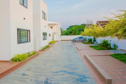a street in a house with a car on it at Pot of Gold East Legon in Accra