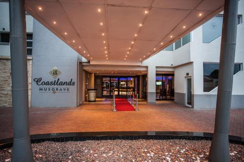 a lobby of a building with a red carpet at Coastlands Musgrave Hotel in Durban
