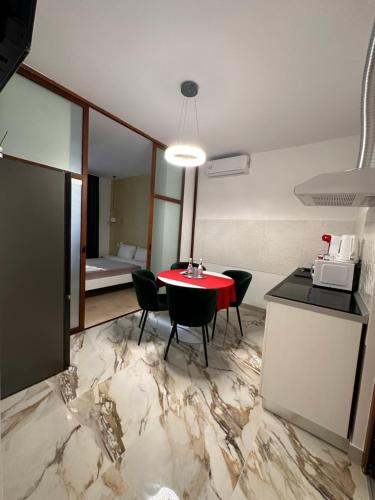 a room with a table and chairs on a marble floor at Fabian Apart CenterTown in Tulcea