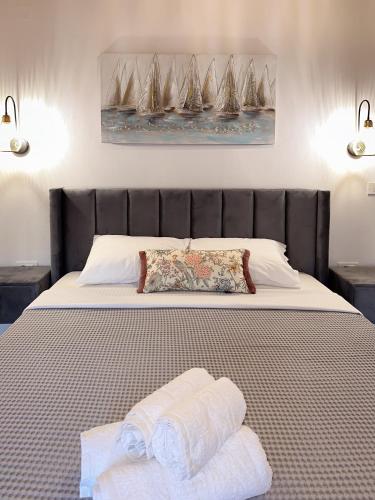 a bed with two towels on top of it at Thetis, the Beach House in Nafplio