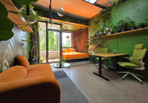 a living room with a couch and a table and some plants at Revitalizér - a calm oasis in the center of Brno in Brno